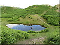 Small tarn on Loughrigg Fell in LA22 9LE