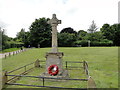 Felbrigg War Memorial with the village sign in the background in NR11 8PL