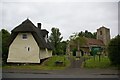 St Bartholomew's church with neighbouring thatched cottage in PE28 4AZ