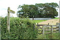 Signpost and Kissing Gate to Cruggleton Church in DG8 8HN