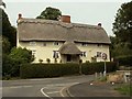 A lovely thatched house at a road junction in Caxton in CB23 3PS
