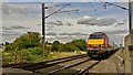 Virgin East Coast train powers past Scrooby crossing in Scrooby