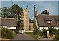 Holy Trinity church and thatched cottages in Elsworth in CB23 4GB