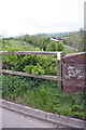 East end of parapet of bridge for B6542 over former railway in CA16 6HX