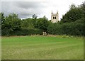 Leighton Bromswold: church tower and kissing gate in Leighton