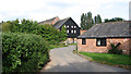 Hall Lane past barn conversions at Hall Farm in NR29 3BL