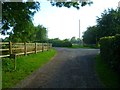 Bridleway bears left at junction with private road in BN18 9PX