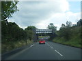 A4109 passes under disused railway bridge in SA10 9HX