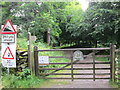 Wooden gate leading to Deer Bolts Wood in LA22 9HQ