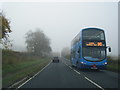 A170 nears Thornton Dale as express bus leaves in YO18 7LX