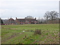 Buildings at Hope Farm seen across field from footpath in RH14 9BP