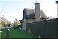Thatched cottage and milestone, Abingdon Road in OX13 5QL