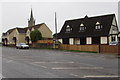 Main road houses and church spire, Stone, Gloucestershire in GL13 9LB