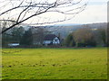 Dwelling at Woodlands Farm seen from footpath to the south in RH12 4HL