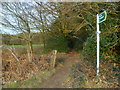 Footpath sign by High Wood in RH12 4HL