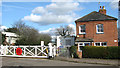 Crossing keeper's cottage and railway crossing in NR13 4FP