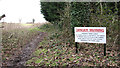 Danger warning beside path to fishing lake in NR9 3HB