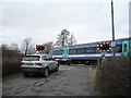 Train passing the level crossing on Brinkley Road, Six Mile Bottom in CB8 0XF
