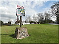 Risby village sign and War Memorial in the background in IP28 6QH