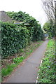 Footpath past ivy-clad cemetery building in OX16 2RR