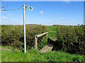 Signpost and footbridge on the path to Rempstone Road in LE12 5EL