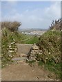 Stone stile and path to Bude Holiday Park in EX23 8NH