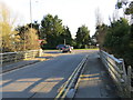 Burmarsh Road joining Hythe Road (A259) over a bridge that spans Hoornes Sewer in TN29 0JS
