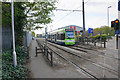 Tram leaving Beddington Lane Tramlink Stop in CR4 1HT