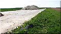 A heap of lime fertiliser stored on the old perimeter track in NR22 6AZ
