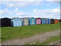 A row of colourful beach huts at Dovercourt in CO12 4EG