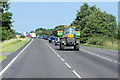 Tractor Heading East along the A17 near to Walpole Cross Keys in PE34 4HB