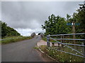 Public footpath signs and farm track crossing the A30 in EX14 3BB