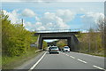 Entering Cambridgeshire and railway bridge, A428 in PE19 2SX