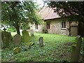 The South wall and Churchyard of All Saints church, Berners Roding, Essex in CM5 0SZ