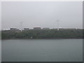 Floating down the Cleddau in the rain - wind turbines and oil storage tanks in SA73 1EE