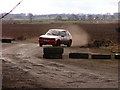 A rally car on one of the perimeter roads at the ex-airfield at Charterhall in Fogo