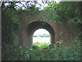 Disused railway bridge, seen from tip of Binny's Wood in CO7 6QH