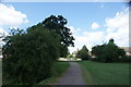 View up the path to Greensted Road from Roding Valley Nature Reserve in IG10 3DG
