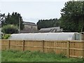 Medieval gatehouse and modern polytunnel in EX16 7HY