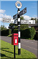 Signpost and postbox, Hethersgill - August 2016 in CA6 6EH