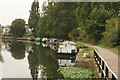 View of boats moored on and being reflected in the River Lea at Markfield Park in N17 9PN