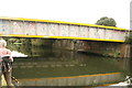 View of the railway bridge reflected in the River Lea at Markfield Park in N17 9PN