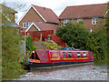 Moored narrowboat by new housing near Nuneaton, Warwickshire in CV10 9QA