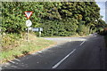 Junction of minor road from Taynton with A424 in OX18 4LS