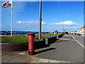 Welsh flag and a pillarbox on Tywyn sea front in LL36 0AW