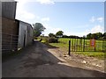 Road passing farm buildings at Lower Upton in SY8 4AZ