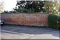 Brick wall beside Crofts End at High Street junction in MK16 9PA