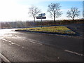 Road junction and grass triangle in CB23 4JQ