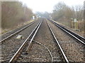 Looking up the railway line from one level crossing to the next in RH13 0NN