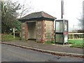 Bus shelter and phone box by Manor Road/Newton Street junction in NR10 3LQ